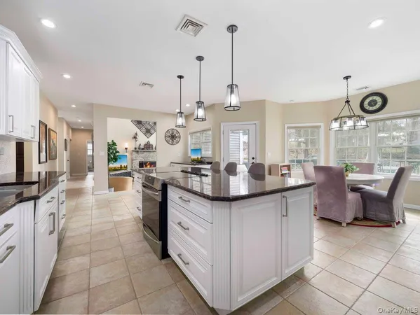 a kitchen with stainless steel appliances kitchen island granite countertop a sink and cabinets