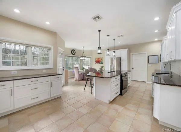 a kitchen with counter top space cabinets and stainless steel appliances