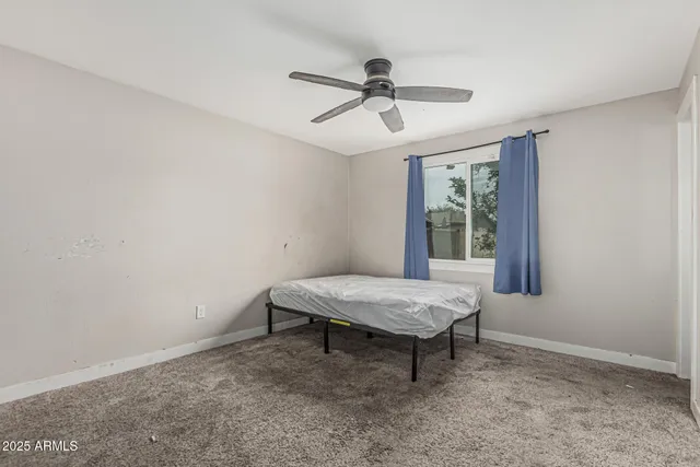a room with wooden floor and windows