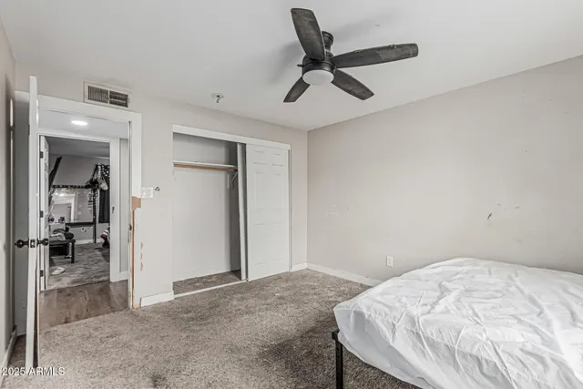 a bedroom with a bed and a view of bathroom