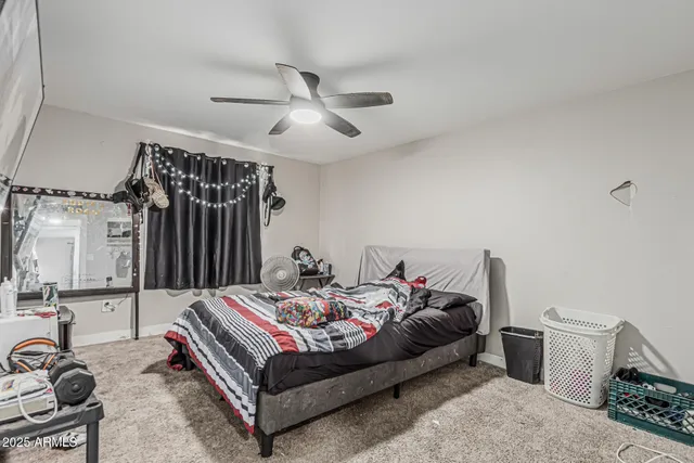 a bedroom with a bed couch and a window