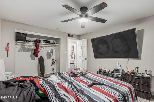 a bedroom with a bed and a flat screen tv