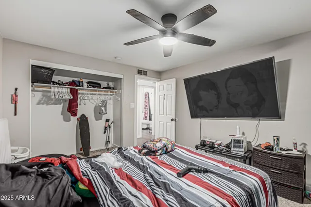 a bedroom with a bed and a flat screen tv