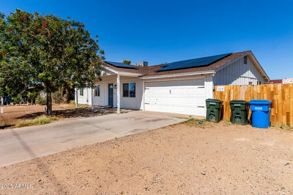 a view of a house with wooden fence