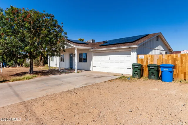 a view of a house with wooden fence