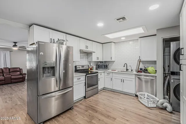 a kitchen with a refrigerator a stove top oven a sink and dishwasher