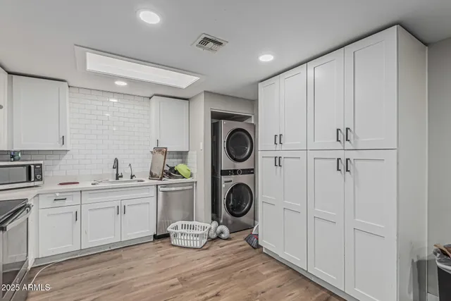 a view of a hallway with washer and dryer