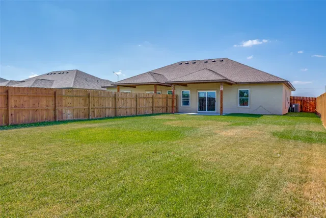 a view of a house with a yard and sitting area
