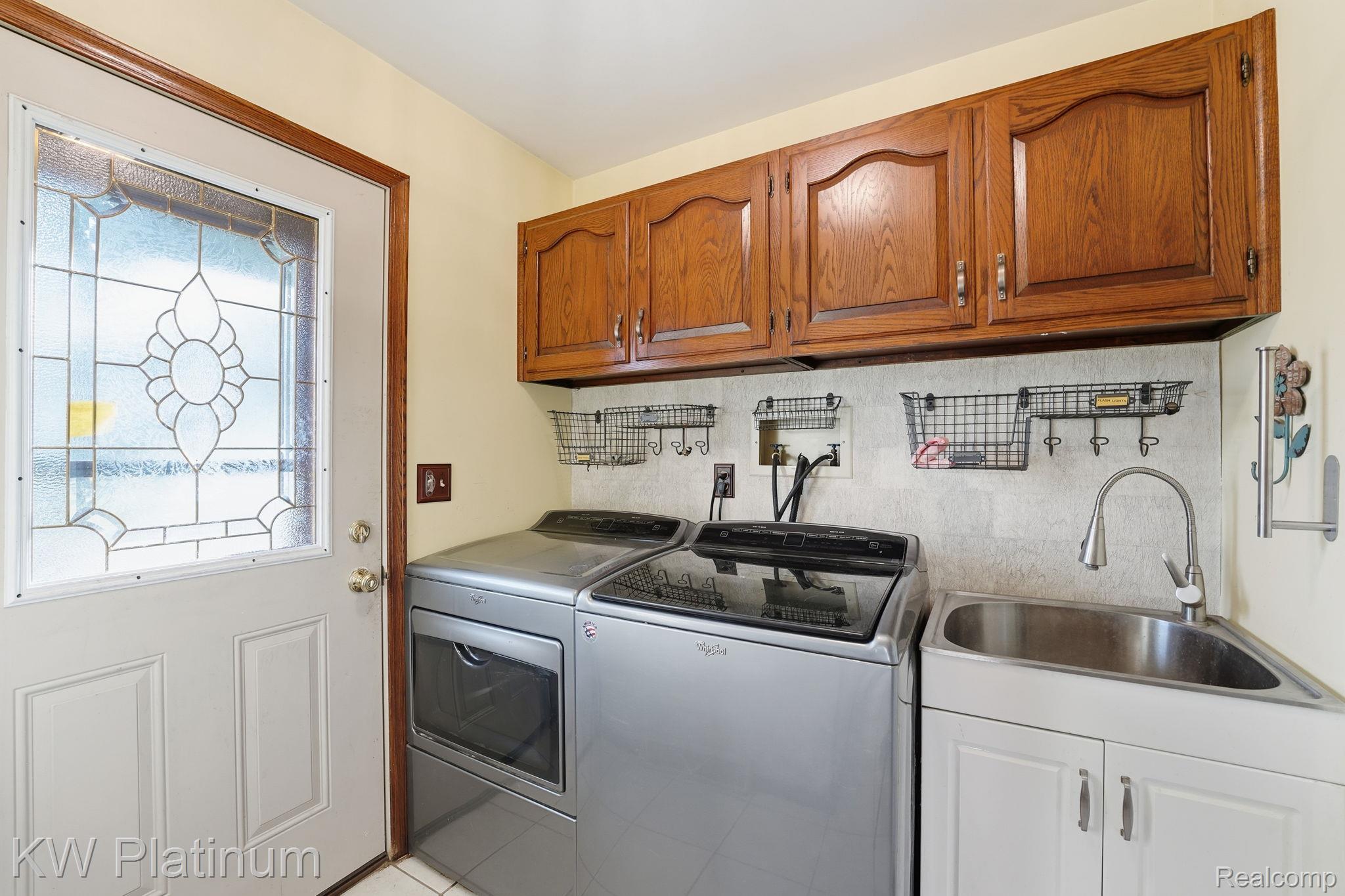 7383 Fisher Road Jeddo, MI 48032 - Photo 20 of 40 Laundry room with cabinet space and washer and clothes dryer
