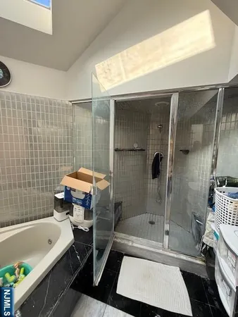 a bathroom with a tub sink and mirror