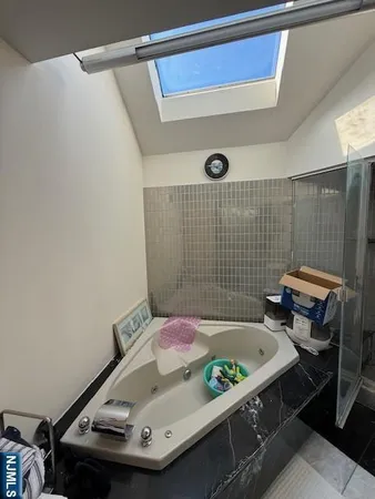 a spacious bedroom with a bed and a desk in it