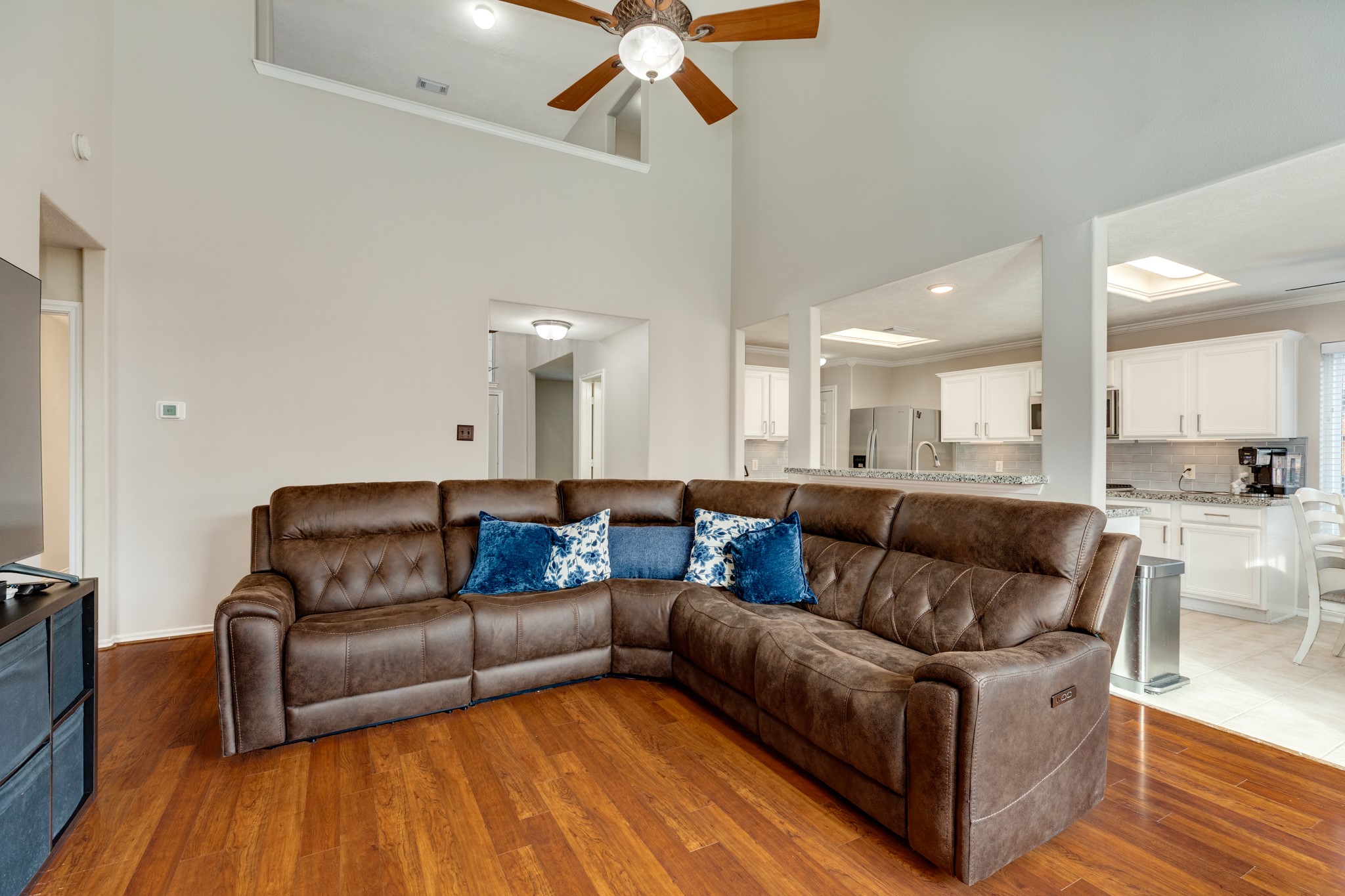 4113 Merlet Drive Pearland, TX 77584 - Photo 10 of 36 This view showcases the seamless flow between the family room and the open-concept kitchen, making it ideal for hosting and entertaining.