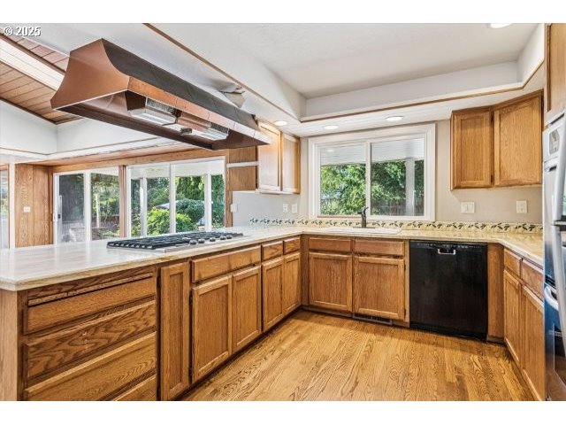 215 Southwest Towle Avenue Gresham, OR 97080 - Photo 16 of 38 a kitchen with granite countertop wooden cabinets a stove a sink and a large window