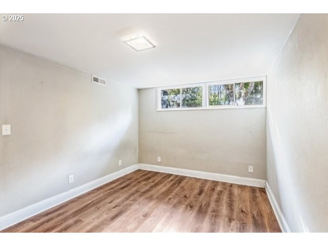 215 Southwest Towle Avenue Gresham, OR 97080 - Photo 29 of 38 an empty room with wooden floor and windows
