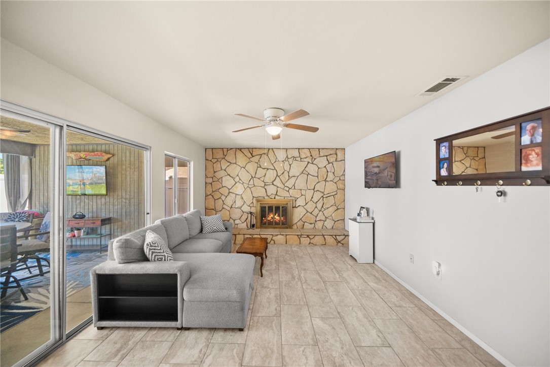 27879 Foxfire Street Menifee, CA 92586 - Photo 18 of 36 a living room with furniture and a chandelier