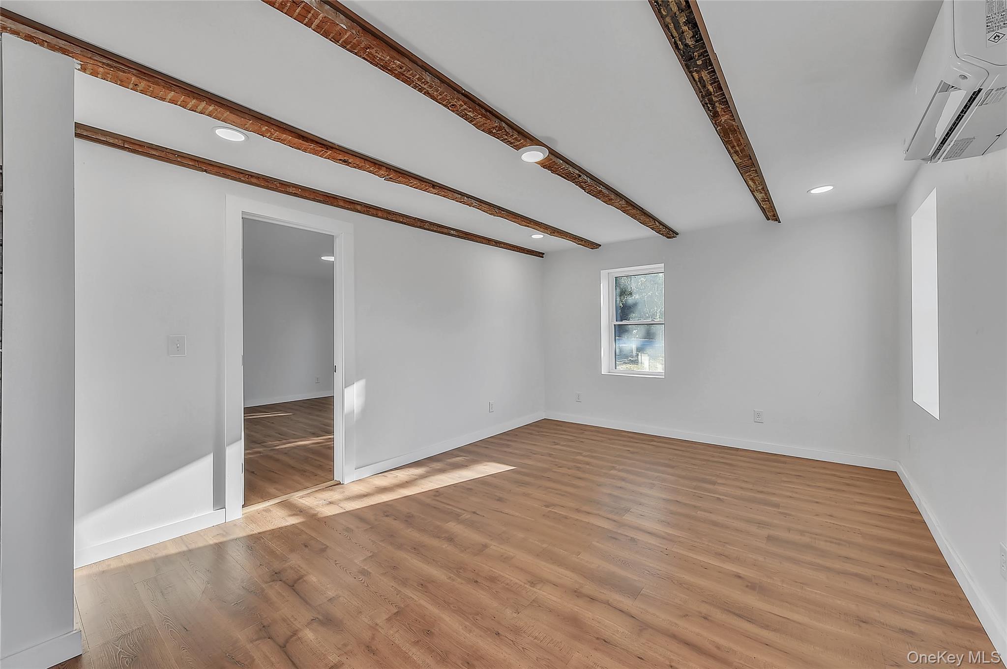 67 Jacobs Road Westtown, NY 10998 - Photo 18 of 35 Spare room featuring recessed lighting, beamed ceiling, cooling unit, and light wood-style flooring