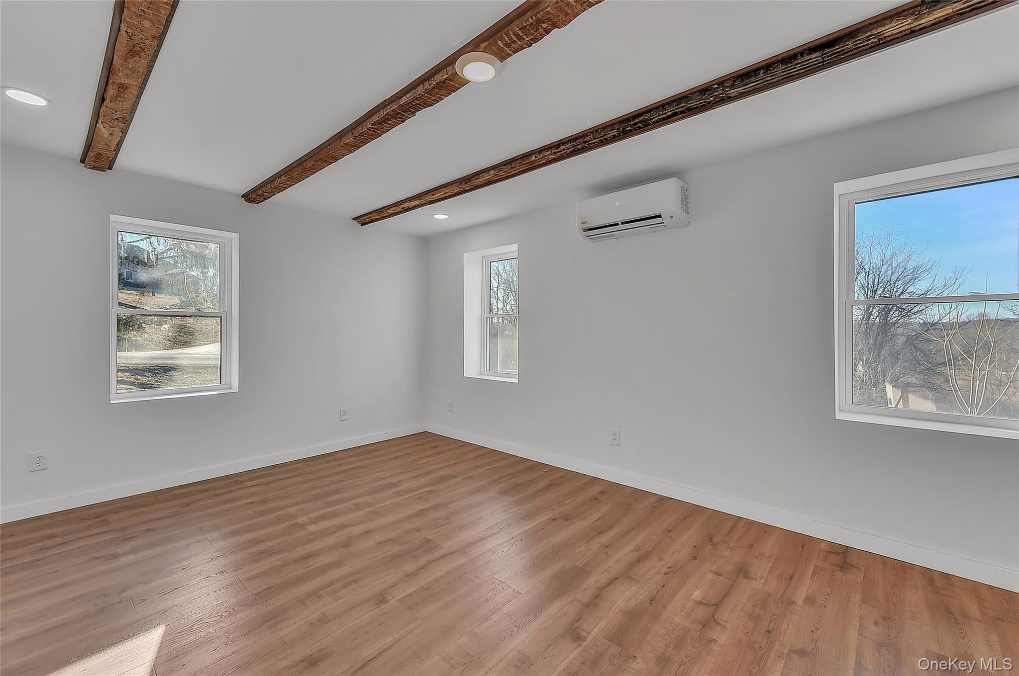 67 Jacobs Road Westtown, NY 10998 - Photo 19 of 35 Spare room with beamed ceiling, wood finished floors, recessed lighting, and a wall unit AC