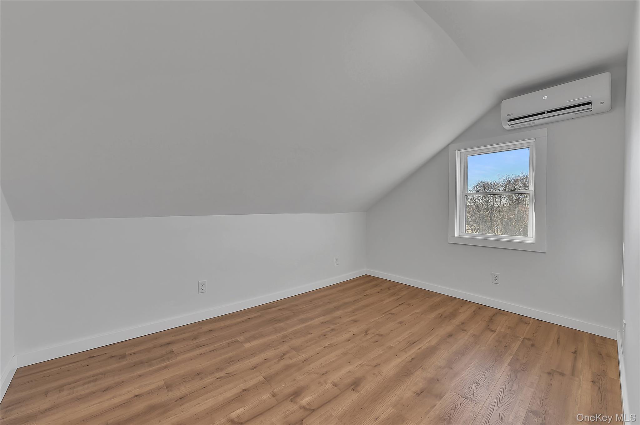 67 Jacobs Road Westtown, NY 10998 - Photo 25 of 35 Additional living space with vaulted ceiling, light wood-style floors, and a wall mounted air conditioner