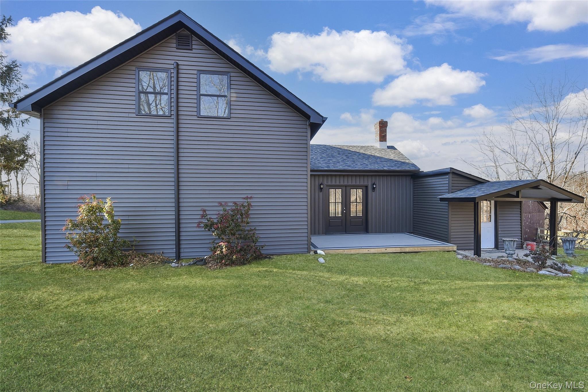67 Jacobs Road Westtown, NY 10998 - Photo 33 of 35 Back of property featuring a lawn, a shingled roof, a deck, and a chimney