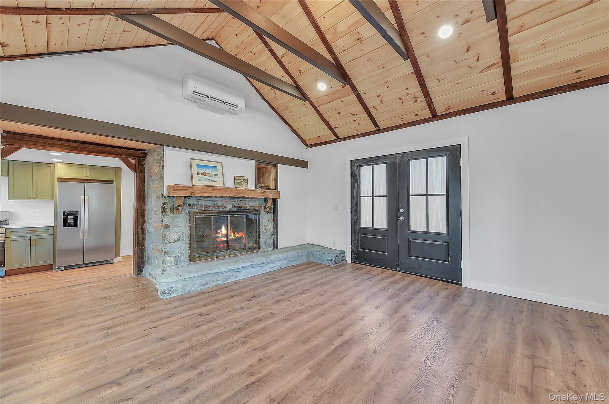 67 Jacobs Road Westtown, NY 10998 - Photo 10 of 35 Unfurnished living room with french doors, high vaulted ceiling, a wood ceiling with exposed beams, a wall mounted AC, and light wood-style floors