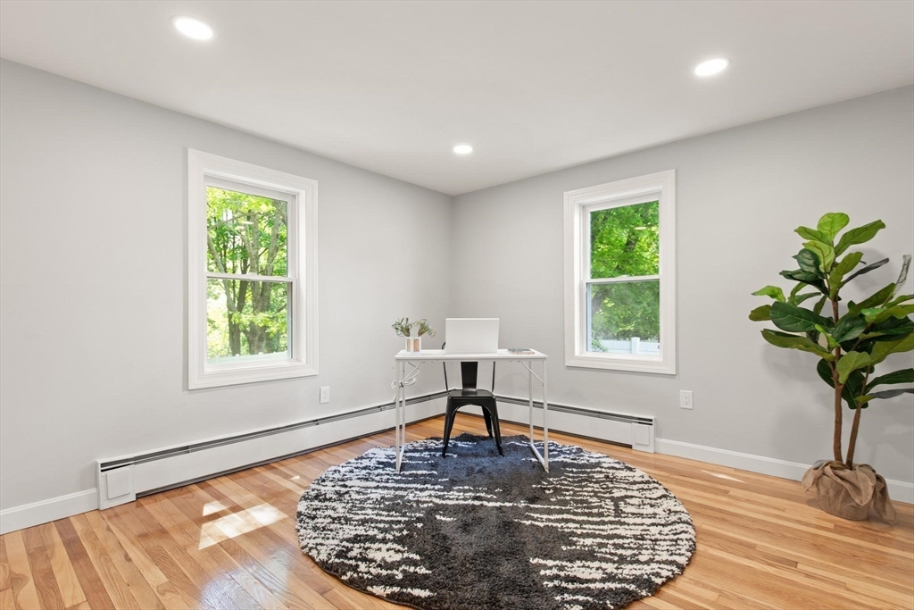 1049 Pleasant Street Canton, MA 02021 - Photo 7 of 16 a living room with furniture and a potted plant