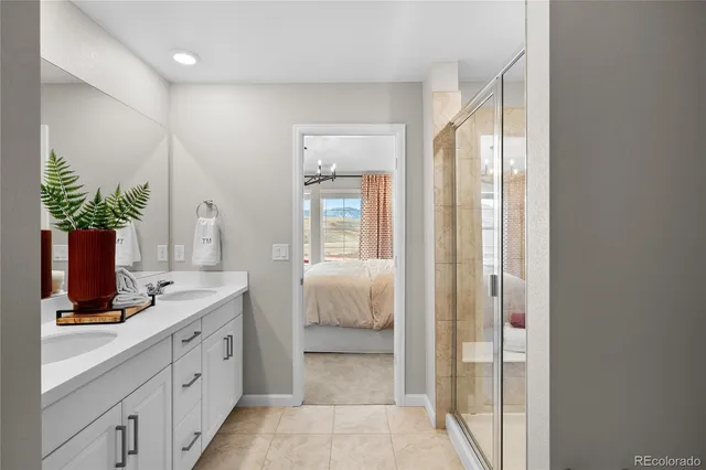 a spacious bathroom with a shower sink and mirror