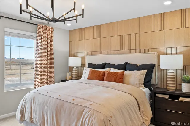 a bedroom with a bed and a chandelier