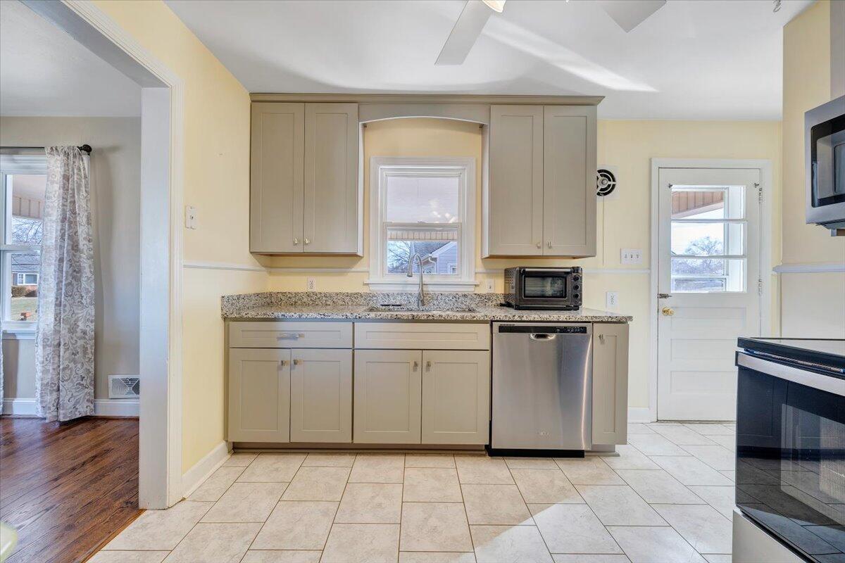 3808 Cove Road Roanoke, VA 24017 - Photo 11 of 34 a kitchen with stainless steel appliances granite countertop a stove a sink and a refrigerator