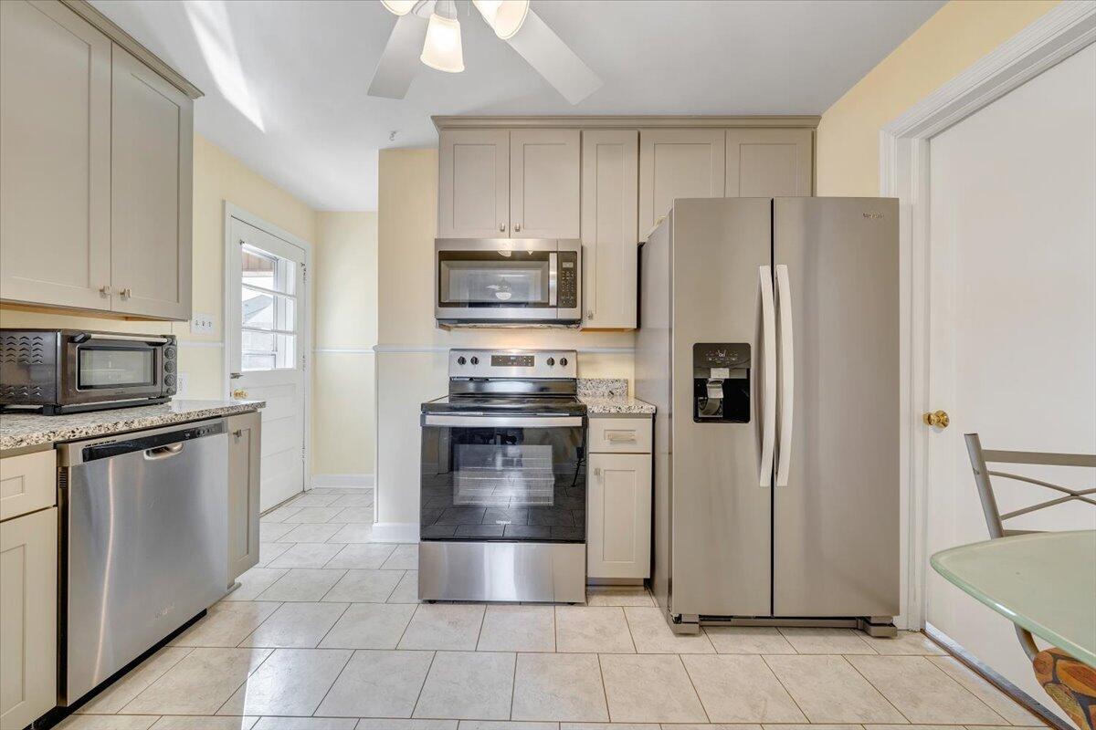 3808 Cove Road Roanoke, VA 24017 - Photo 12 of 34 a kitchen with granite countertop a refrigerator and a stove top oven