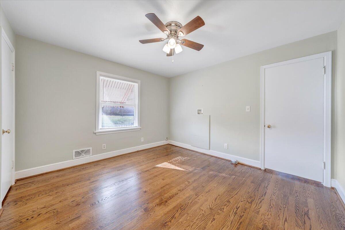 3808 Cove Road Roanoke, VA 24017 - Photo 18 of 34 a view of an empty room with window and wooden floor