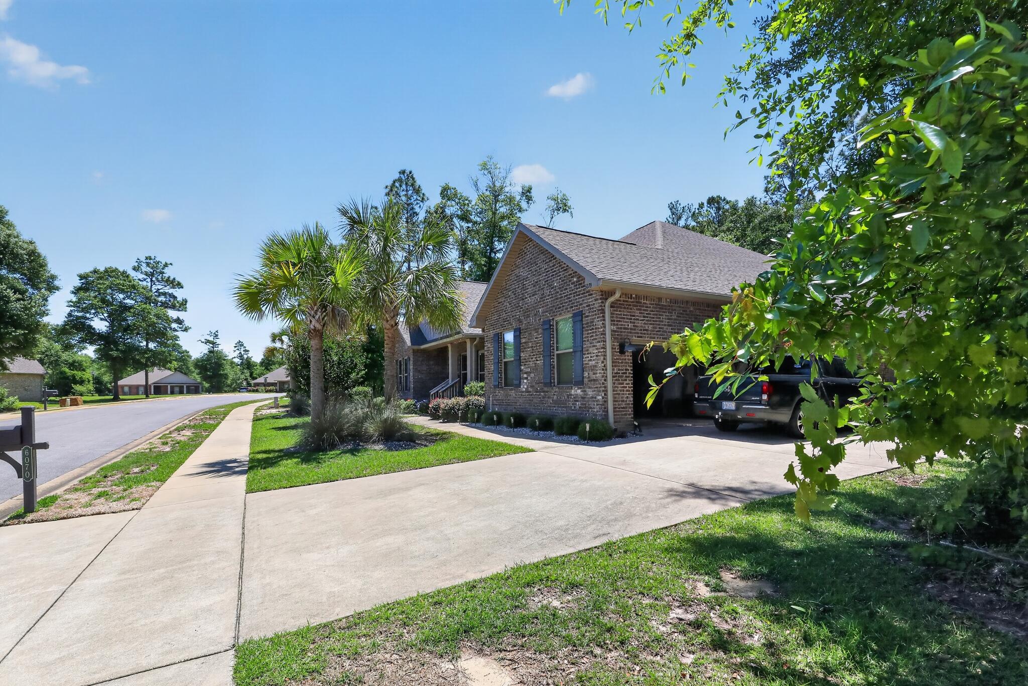 6070 Carina Road Crestview, FL 32539 - Photo 2 of 10 a front view of a house with a yard and trees
