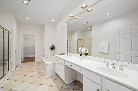 a spacious bathroom with a double vanity sink mirror double and shower