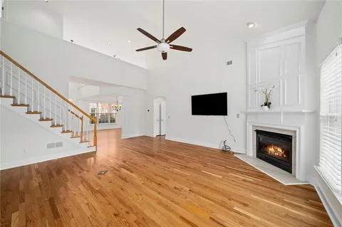 a view of empty room with wooden floor and fireplace