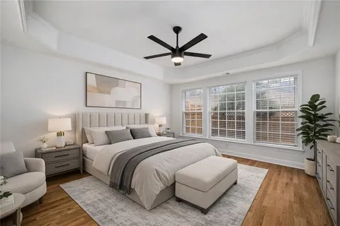 a spacious bedroom with a bed and a large window
