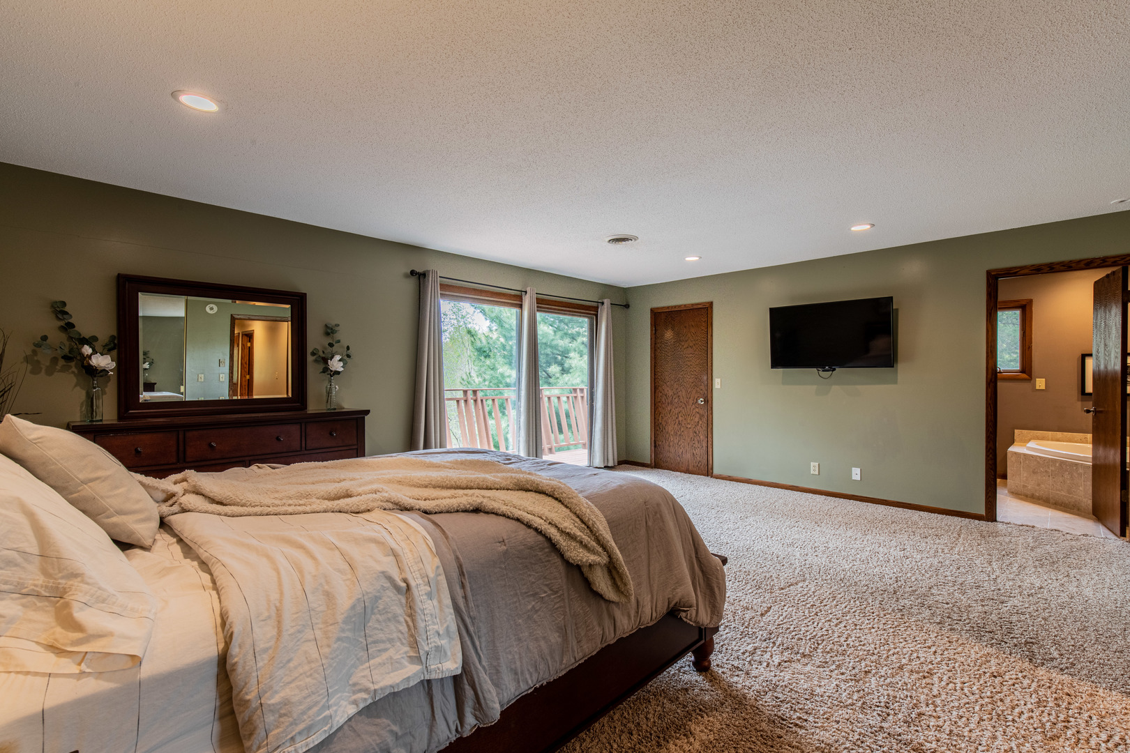 1000 Timber Ridge Road Princeton, IL 61356 - Photo 30 of 55 a bedroom with a large bed and a flat screen tv