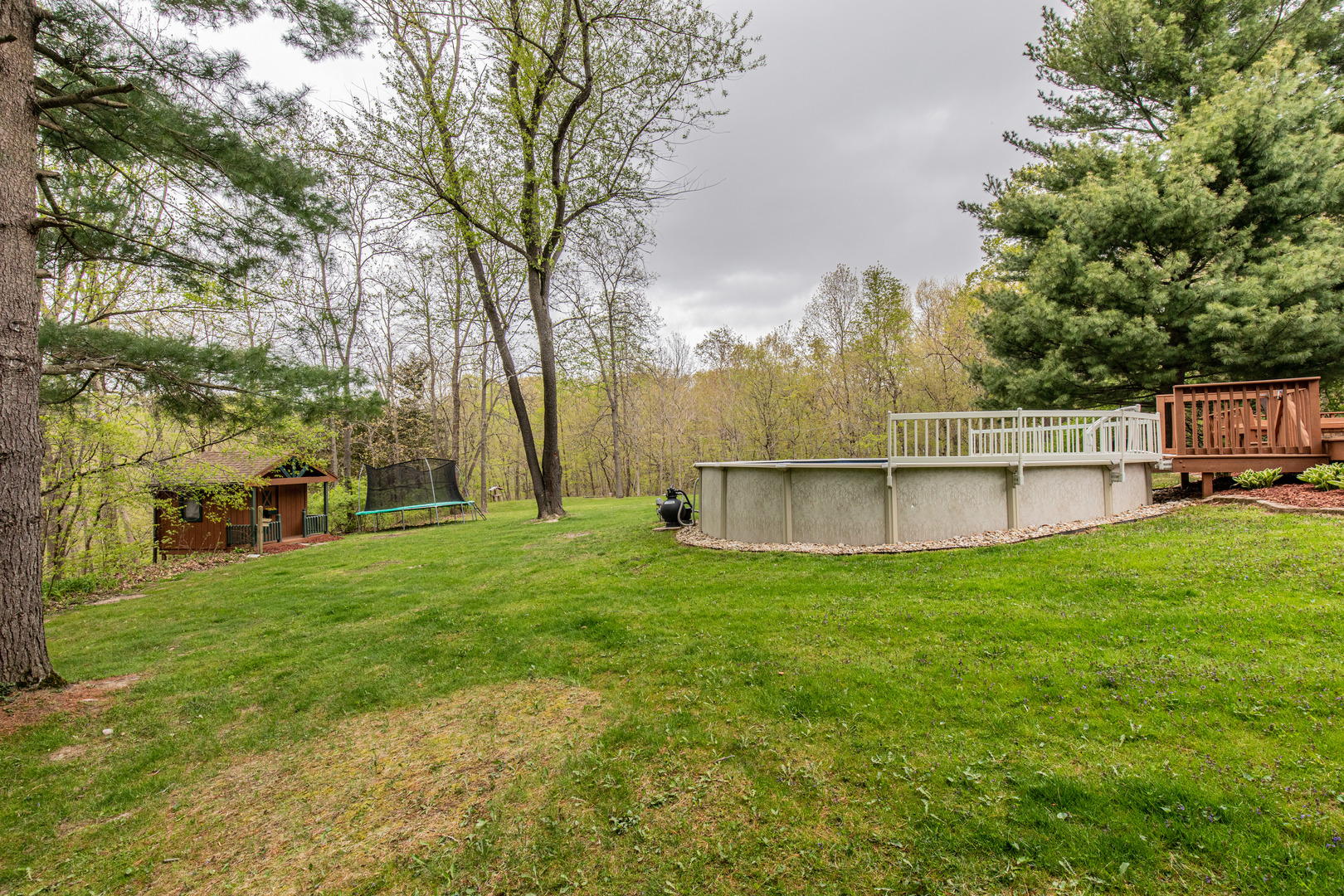 1000 Timber Ridge Road Princeton, IL 61356 - Photo 45 of 55 a view of a yard with large trees and a wooden fence