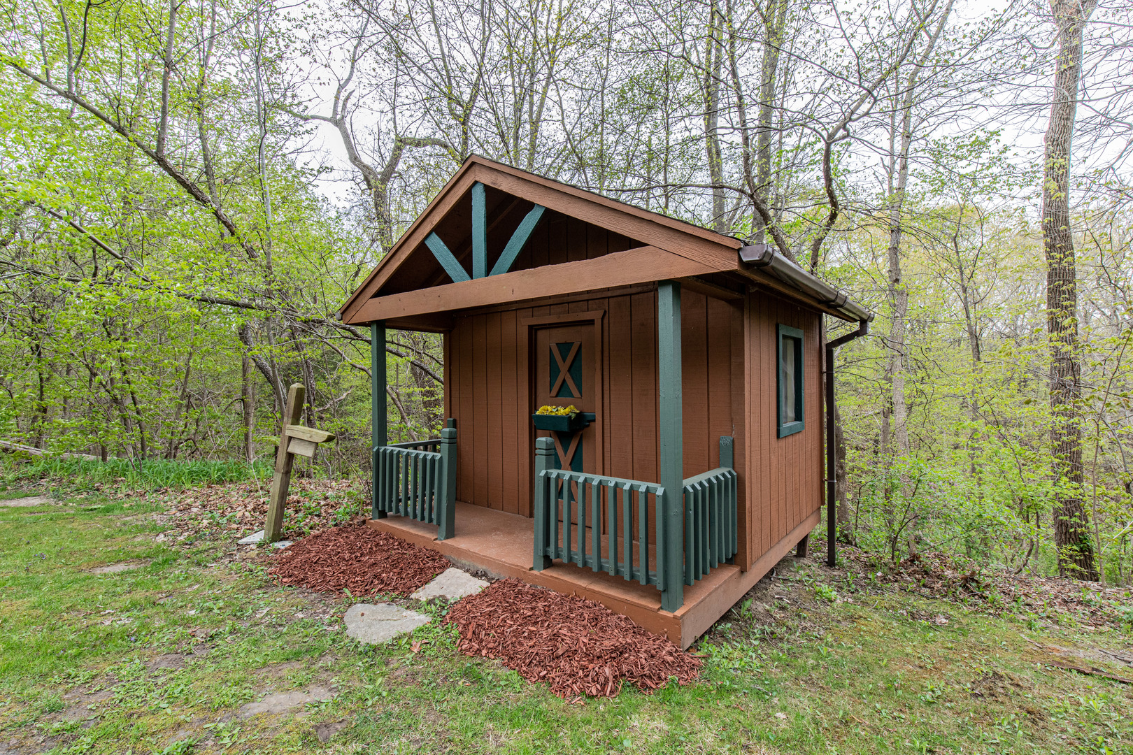 1000 Timber Ridge Road Princeton, IL 61356 - Photo 51 of 55 a view of a small house with wooden fence and large trees
