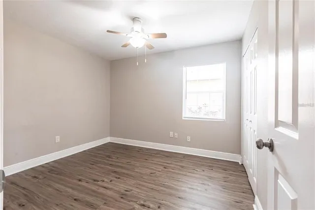 wooden floor in an empty room with a window
