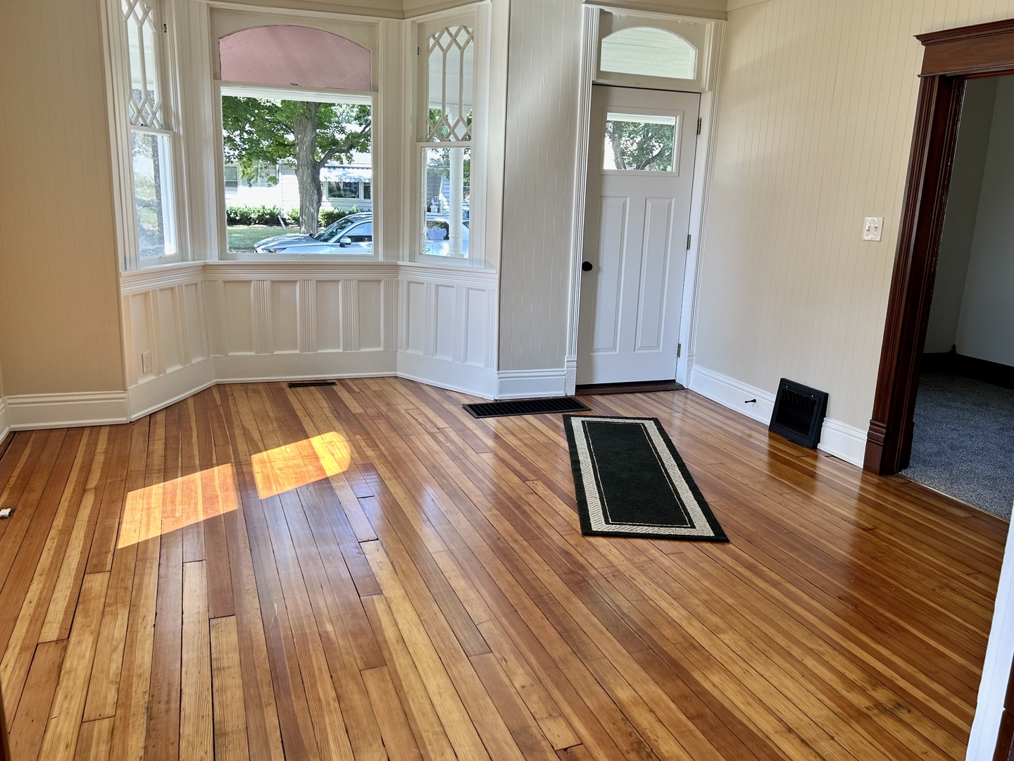 109 South Bureau Avenue Ladd, IL 61329 - Photo 4 of 23 an empty room with wooden floor and windows