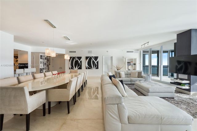 a kitchen with stainless steel appliances a sink a stove a microwave a sink a refrigerator and cabinets