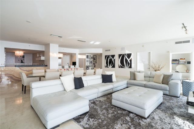 a kitchen with a refrigerator an oven and cabinets