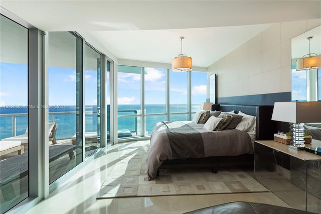 a bathroom with a granite countertop toilet sink and mirror
