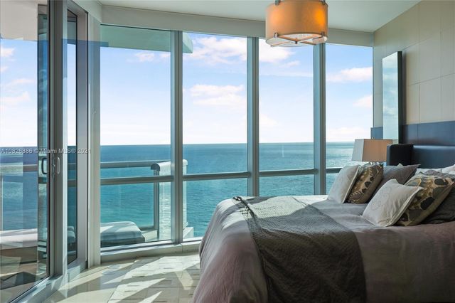 a view of a hallway with a livingroom and a bathroom