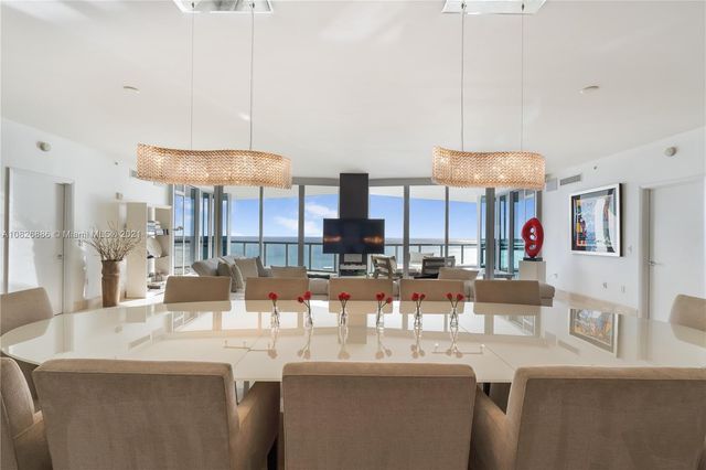 a living room with furniture and view of kitchen