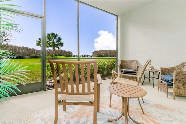 a view of a chairs with a table and chair in patio