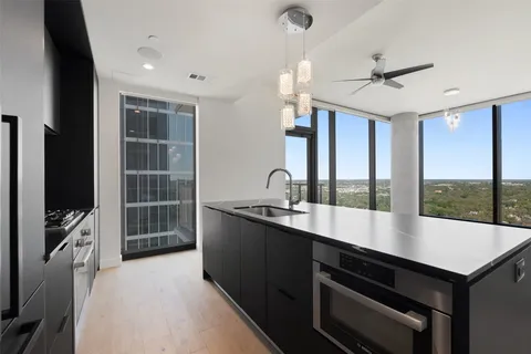 a large kitchen with kitchen island a sink stainless steel appliances and a counter top space