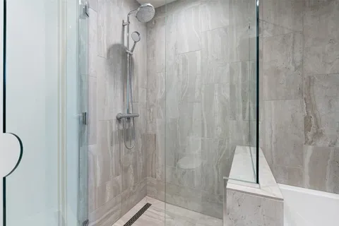 a bathroom with a bathtub and a shower