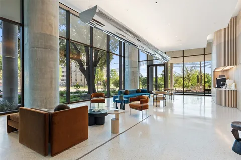a large living room with large couches and flat screen tv