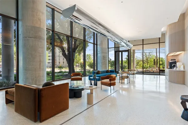 a large living room with large couches and flat screen tv