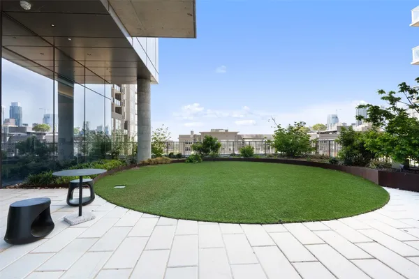 a view of a swimming pool with outdoor seating and plants
